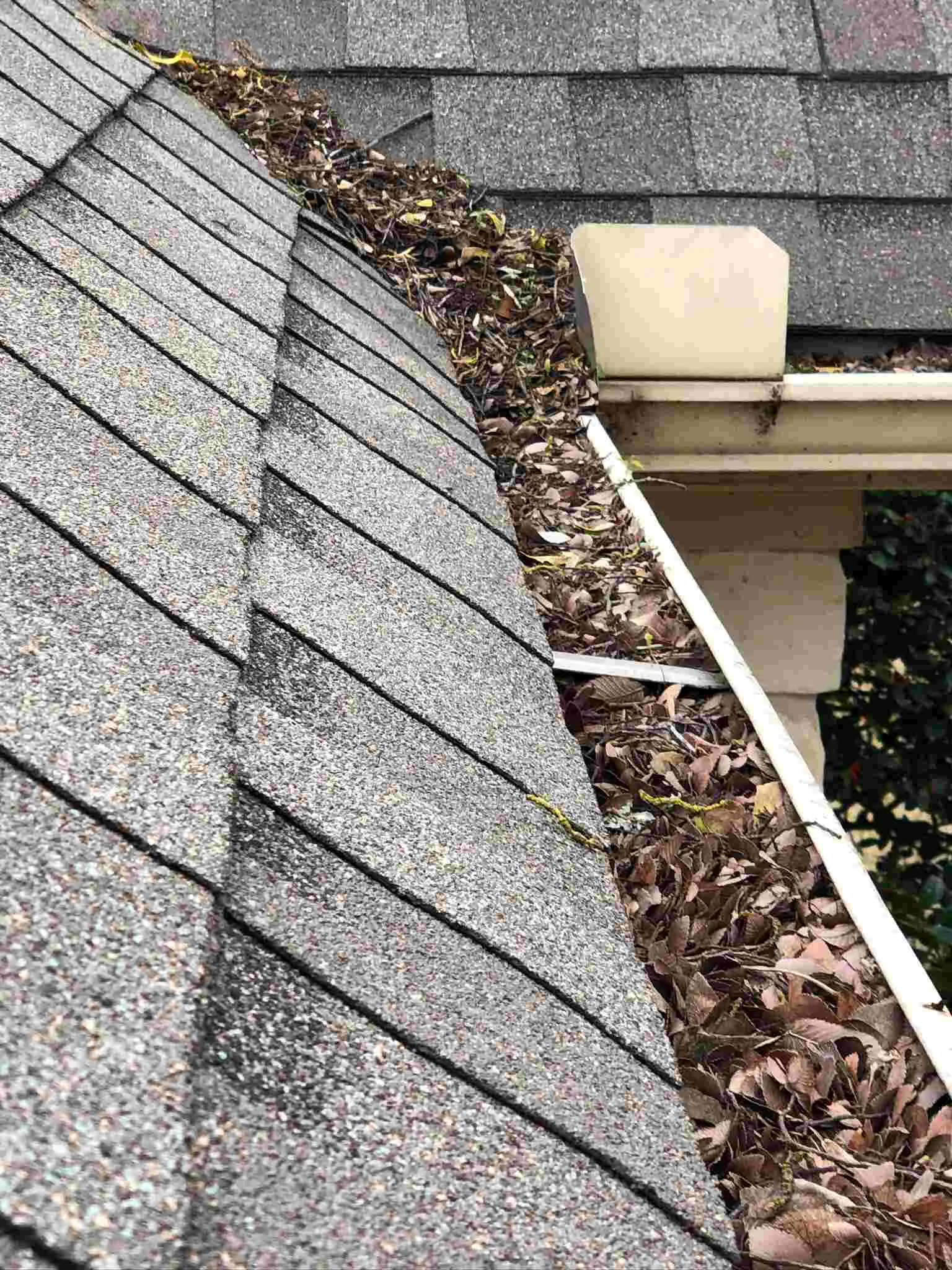 A gutter that is on the side of a roof.