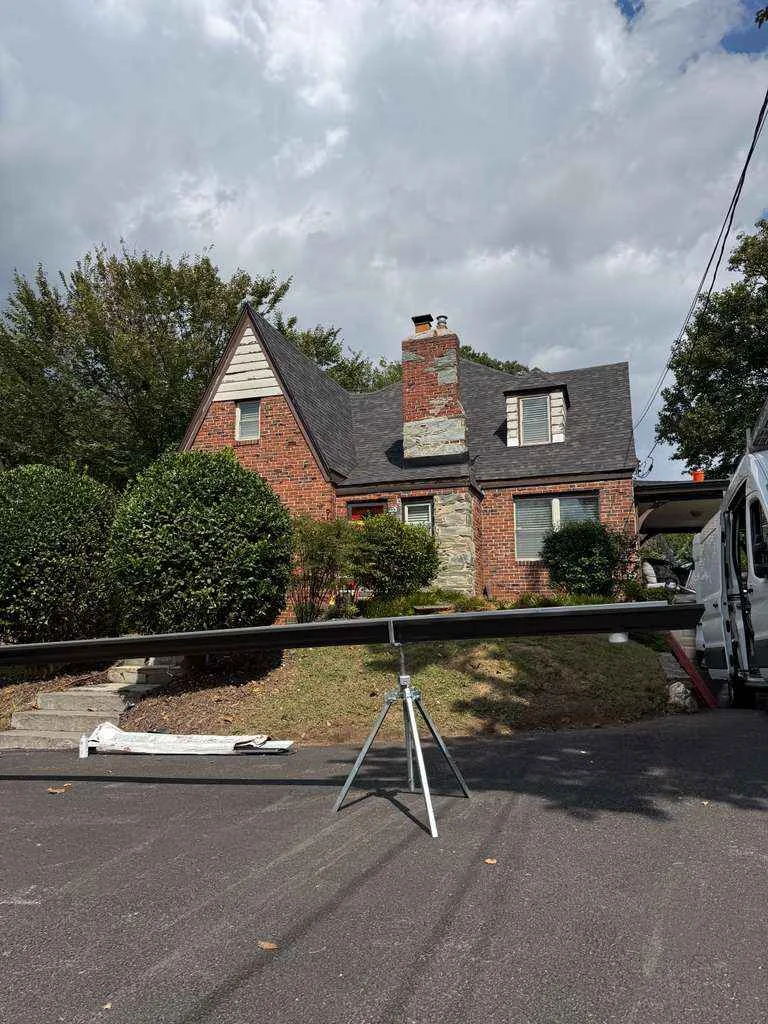 Professional seamless gutter installation on residential roof