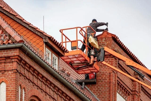 Professional roofer installing roofing system for Takoma Park MD homeowner