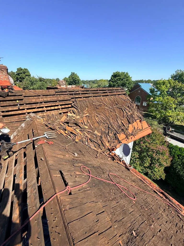 Old roof torn off exposing damaged plank decking on a Laurel, MD home