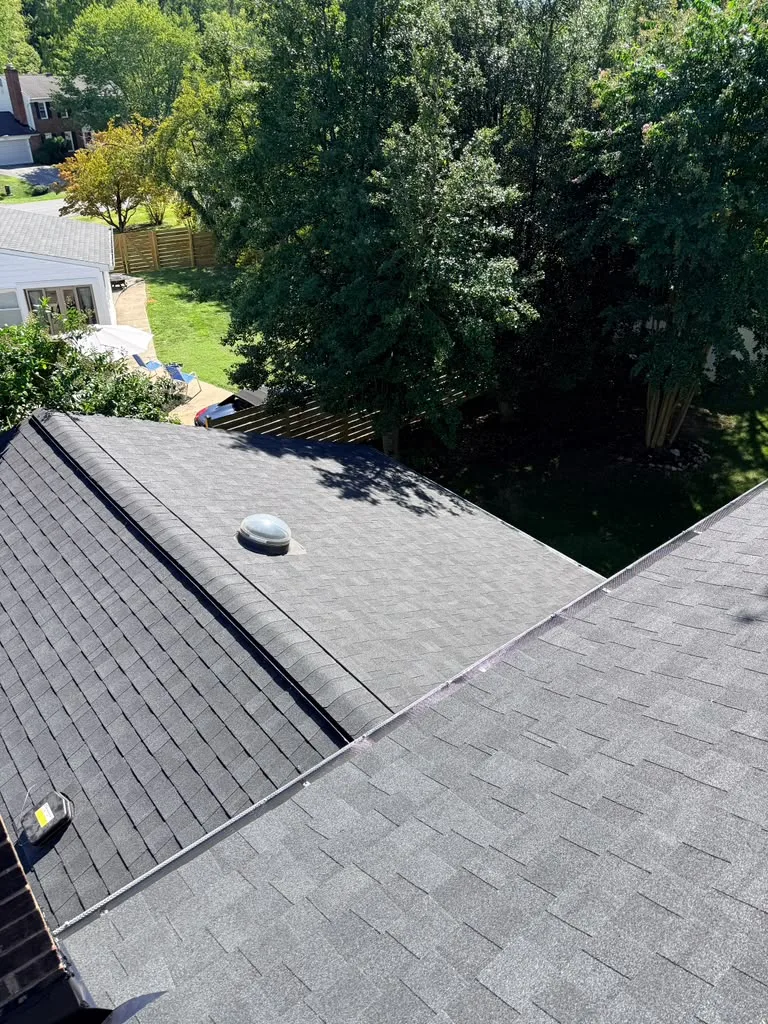 New architectural shingle roof with ridge vent and sun tunnel installed